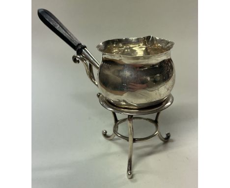 HUKIN &amp; HEATH: A silver brandy warmer on a stand. London 1901. Approx. 66 grams. Est. £60 - £80.