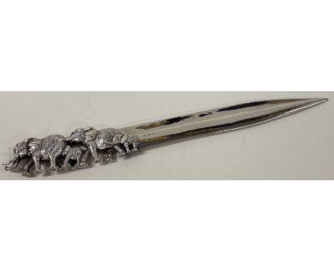 PATRICK MAVROS: A silver letter opener cast with elephants of naturalistic design. Approx. 99 grams. Est. £300 - £500.