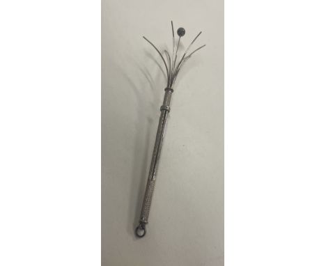 A silver engine turned twizzle stick. Approx. 5 grams. Est. £30 - £50. 