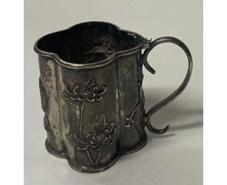 A 19th Century Chinese chased silver toy mug embossed with dragons and bamboo. Marked to base. Approx. 34 grams. Est. £30 - £