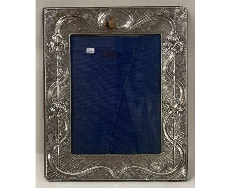 An Arts and Crafts decorative Edwardian chased silver photo frame. Birmingham 1902. By A &amp; J Zimmerman. Est. £300 - £500.