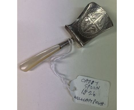 A silver caddy spoon with MOP handle. Birmingham 1826. By William Pugh. Approx. 8 grams. Est. £80 - £120.