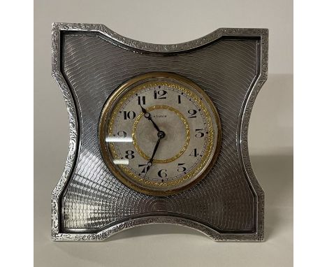 A large engine turned silver clock. London 1925. By Goldsmiths. Approx. 307 grams. Est. £150 - £200.