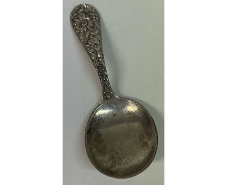 A fine American chased silver caddy spoon. By Kirk &amp; Son. Approx. 146 grams. Est. £40 - £80.