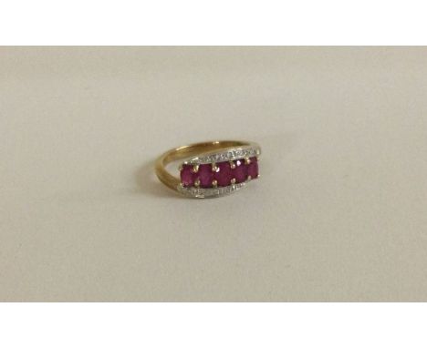 A ruby and diamond three row crossover ring in 9 carat mount. Approx. 2.5 grams. Est. £250 - £300.