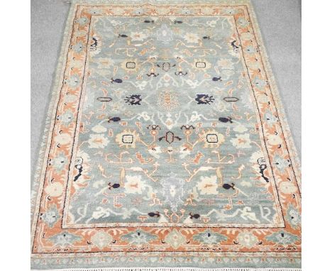 A woollen rug, with a foliate design, on a green ground, 257 x 177cmCondition report: Overall looks to be complete. Has a ver