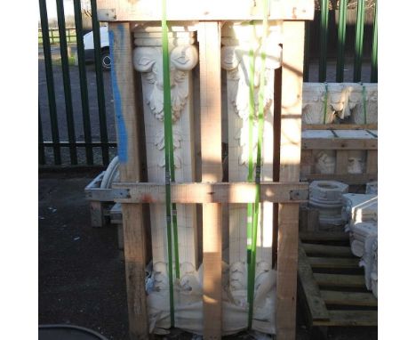 A pair of architectural white carved marble columns, with mask decoration, 128cm high (2)