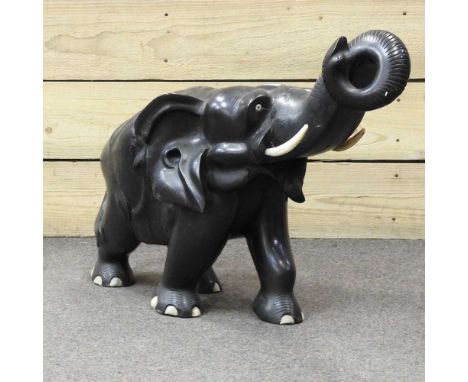 A large African carved ebony model of an elephant, 65cm long