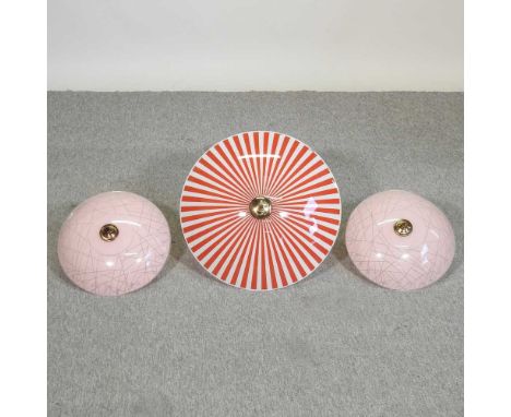 A pair of mid 20th century pink glass ceiling lights, together with a red striped glass ceiling light, 48cm diameter (3)