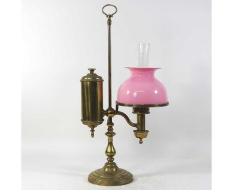 An 19th century brass adjustable student's lamp, with a pink opaque glass shade, 53cm high overall