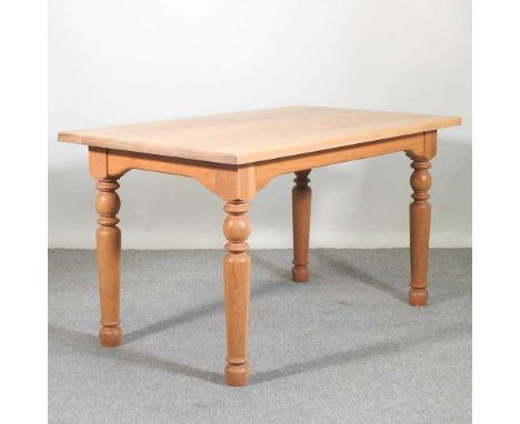 A modern light oak dining table, on turned legs137 x 80 x 77h cm