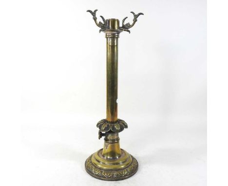 An 19th century patent brass candle lamp, with a lappet column and adjustable wick, stamped patent London 2035, 47cm high ove