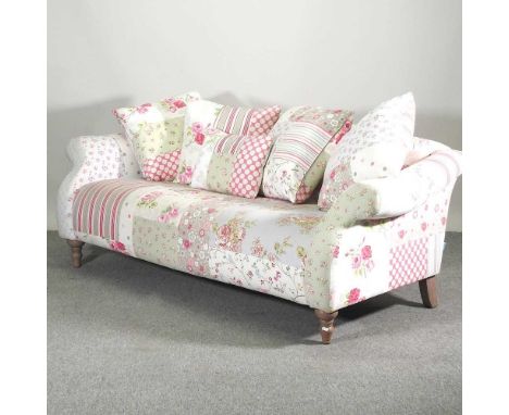 A modern floral patchwork Capsule Collection upholstered sofa, with floral designs, with loose cushions,200w x 80h x 70d cmCo