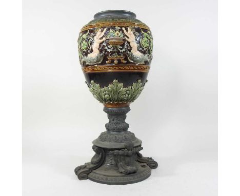 A 19th century majolica oil lamp base, decorated in relief with a frieze of cherubs, on an ornate spelter base, 44cm highCond