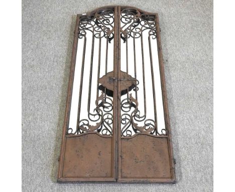 A rusted iron garden mirror, of hinged gate design, 128 x 52cm