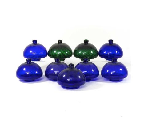 A collection of seven blue and two green glass oil lamp fonts, 13cm high