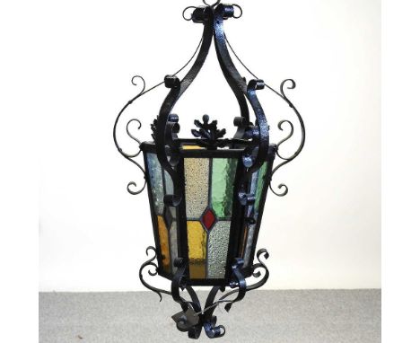 An iron lantern, with stained glass panels, 54cm highCondition report: Overall condition look complete. The glass panels appe