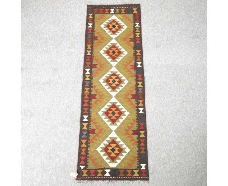 A Turkish kelim runner, with a row of five central medallions, 199 x 63cm