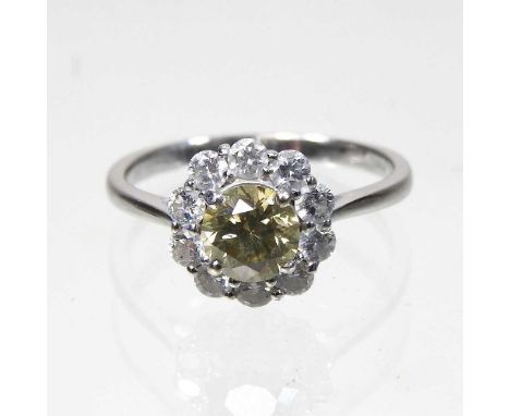 An 18 carat white gold fancy yellow diamond cluster ring, approximately 1.5 carats gross, size O, boxed with certificate and 