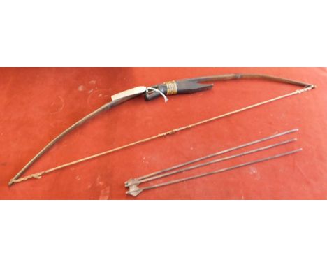 Antique Asian bow and arrow made from bamboo with three arrows, it has an ornamental handle carved in the shape of a snake or