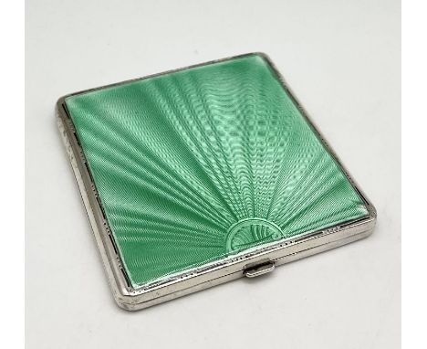 An Art Deco silver compact decorated with green guilloche enamel- slight chip to enamel