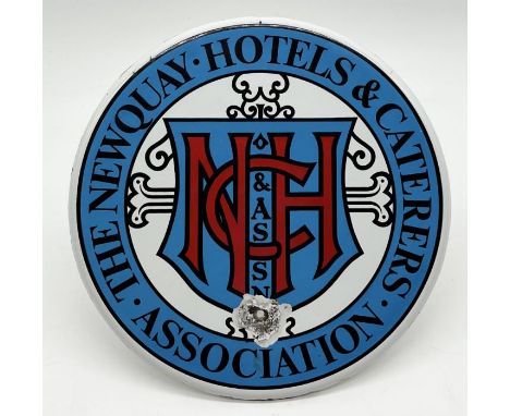 A round enamel sign for "The Newquay Hotels &amp; Caterers Association" - 23cm diameter 
