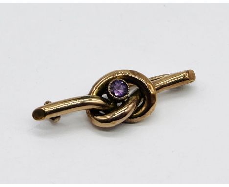A 9ct rose gold knot brooch set with an amethyst, weight 2.2g
