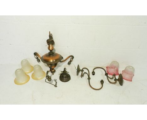 An antique three branch central ceiling light with glass shades along with a pair of similar wall lights with cranberry glass