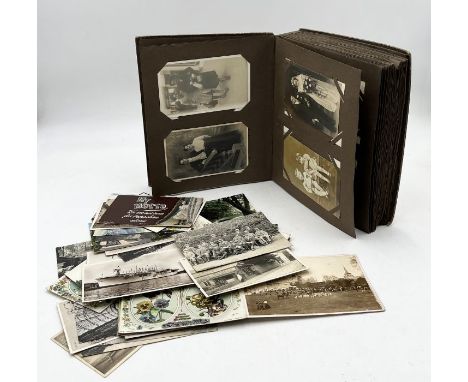 A collection of vintage postcards loose and in one album showing family life, nursing, country views etc. 