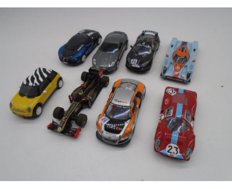 A collection of eight vintage Hornby Scalextric cars including an Aston Martin, Lotus Evora, Lotus F1 Racing Car, Mini Cooper