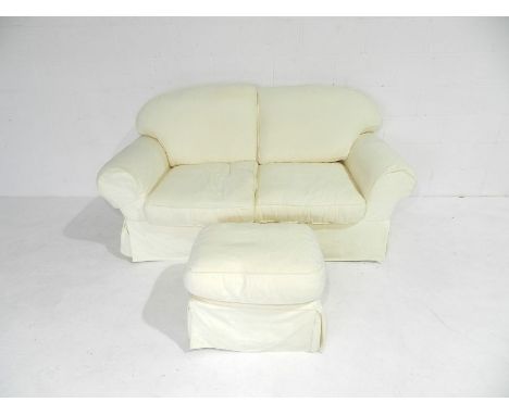 A two seater sofa with loose covers along with a pouffe - length 188cm