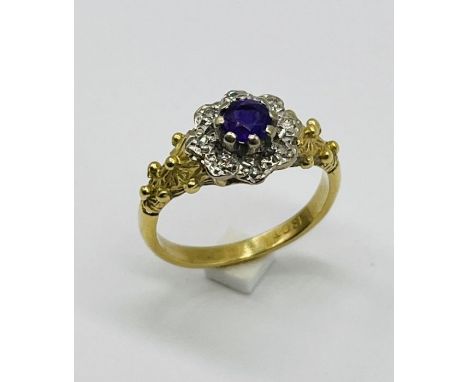 An amethyst and diamond cluster ring set in 18ct gold