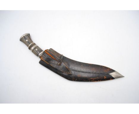 A kukri knife with leather scabbard