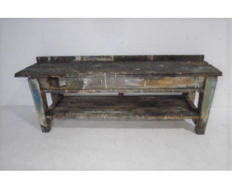 An industrial work bench with shelf under. 210cm x 55cm. Height 75cm (work surface) 78cm (back board)