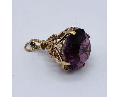 A 9ct gold fob set with an amethyst coloured stone 