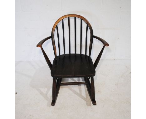 A child's Ercol dark wood rocking chair