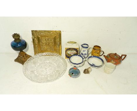 A quantity of ceramics and glassware including a Victorian oil lamp, Royal Cauldon tea caddy, Royal Doulton cat etc. over two