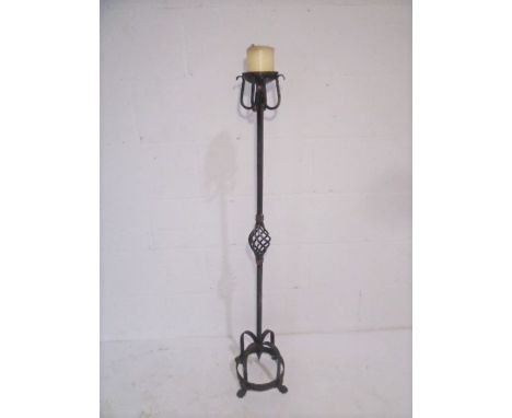 A tall wrought iron vintage candlestick holder.