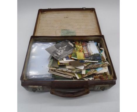 A vintage luggage case 36cm x 23cm x12cm with the initials H.P.R. containing assortment of vintage world wide postcards, Lot 