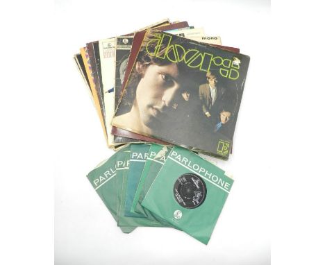 A small collection of 12" and 7" vinyl records comprising of The Doors, The Beatles, Paul and Linda McCartney and The Rolling