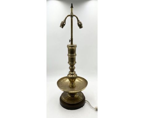 An Eastern brass table lamp on turned wooden base 