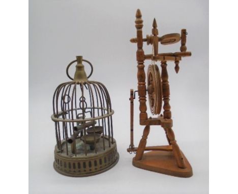 A miniature brass bird cage with a spinning wheel model (height 24cm).