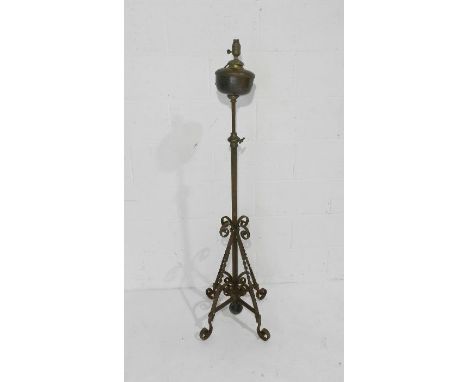 A converted oil lamp on wrought iron stand