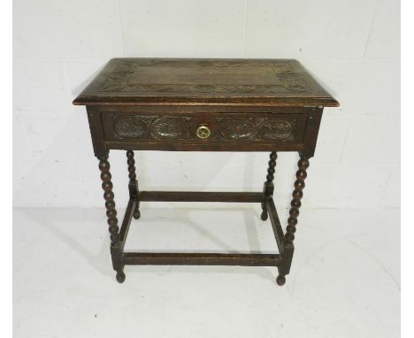 A carved oak hall table with single drawer, raised on bobbin turned legs - length 69cm, depth 44cm, height 72cm