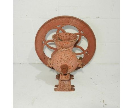 An antique painted grain grinder, marked 'Meech's Surprise'