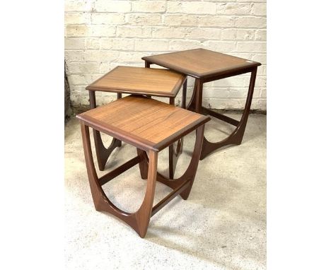 G-Plan - A Vintage teak nest of three tables, the square tops raised on shaped supports H52cm, 51cm x 51cm