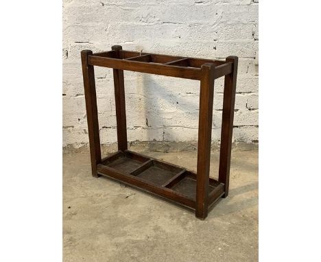 An early 20th century stained walnut two division stick stand on stile supports H75cm, W76cm, D28cm