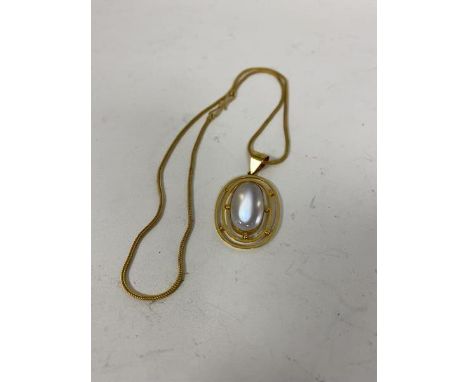 A moonstone cabouchon within a 9ct gold pendant, marked CM &amp; Co. on a yellow metal chain (21cm) (5.88g)