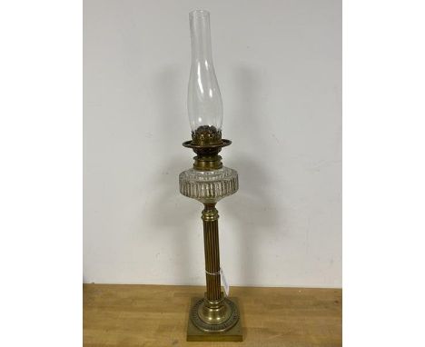 An early 20thc oil burning lamp, the shade marked Griffin Brand above circular well on column base (74cm)