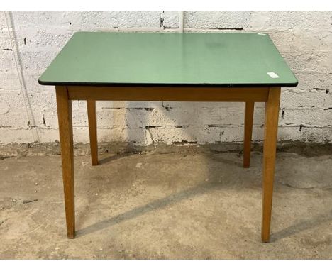 A mid century vintage table, with green formica top raised on splayed beech supports H76cm, W92cm, D61cm